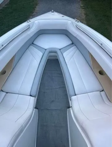 Slide: The Image of 1998 Cobalt 252 boat interior with white cushioned seating. - 3