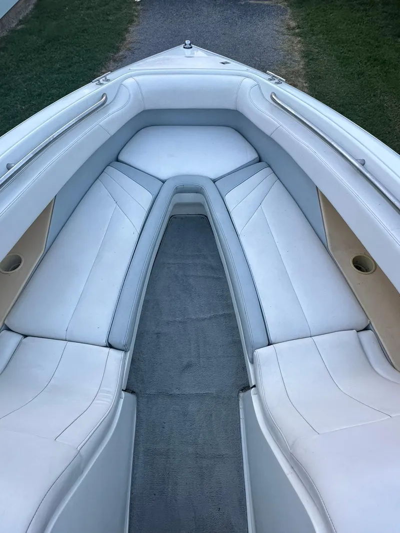 Slide: The Image of 1998 Cobalt 252 boat interior with white cushioned seating. - 4