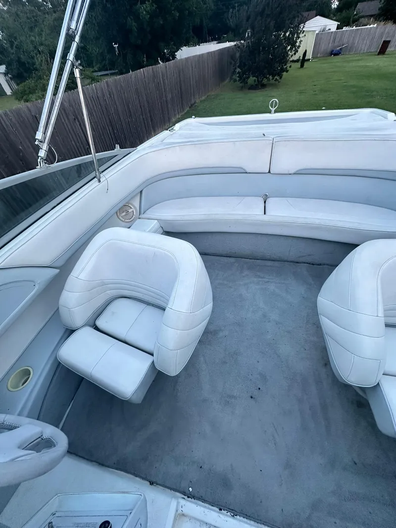 Slide: The Image of 1998 Cobalt 252 boat interior with white seating and open deck. - 6