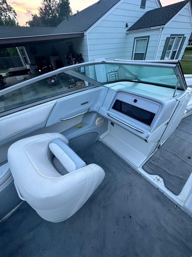 Slide: The Image of 1998 Cobalt 252 boat interior with white seating and dashboard. - 9