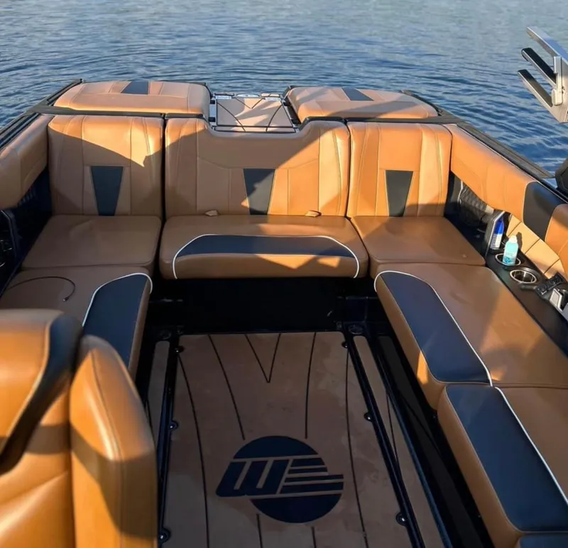 Slide: The Image of 2022 Malibu Wakesetter 23 LSV interior with tan and black seating on water. - 5