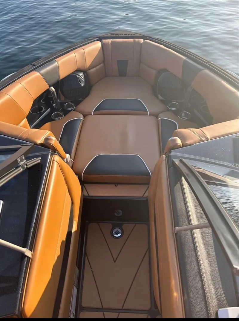 Slide: The Image of 2022 Malibu Wakesetter 23 LSV interior, tan and black seating, on water. - 6
