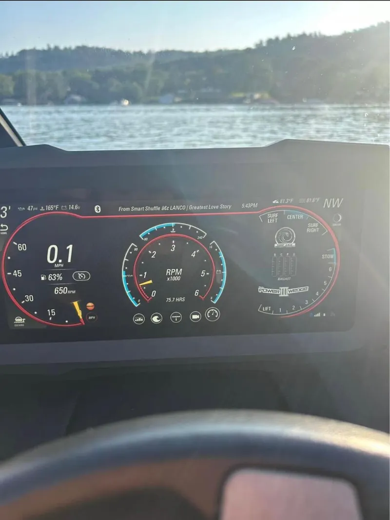 Slide: The Image of 2022 Malibu Wakesetter 23 LSV dashboard display with lake view in background. - 7