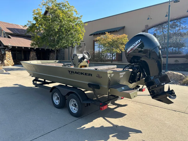 Slide: The Image of 2025 Tracker Grizzly 2072 CC boat with Mercury engine on trailer. - 2