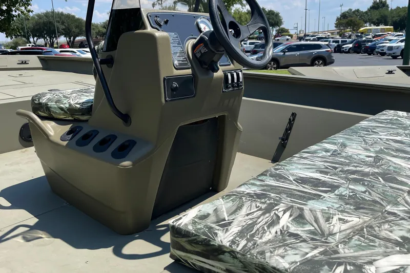Slide: The Image of 2025 Tracker Grizzly 2072 CC boat interior with camouflage seating and steering console. - 4