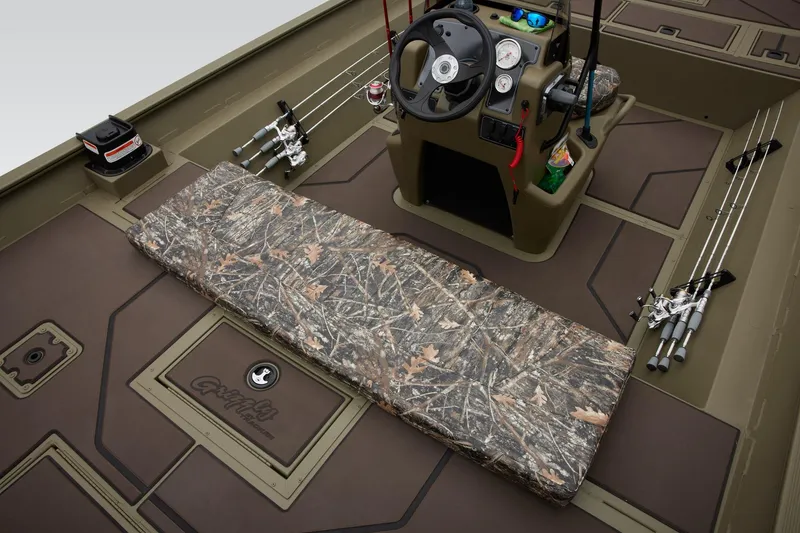 Slide: The Image of 2025 Tracker Grizzly 2072 CC boat interior with camo seating and fishing rods. - 42
