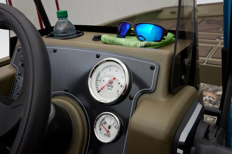 Slide: The Image of 2025 Tracker Grizzly 2072 CC dashboard with RPM and fuel gauges, sunglasses, and water bottle. - 47