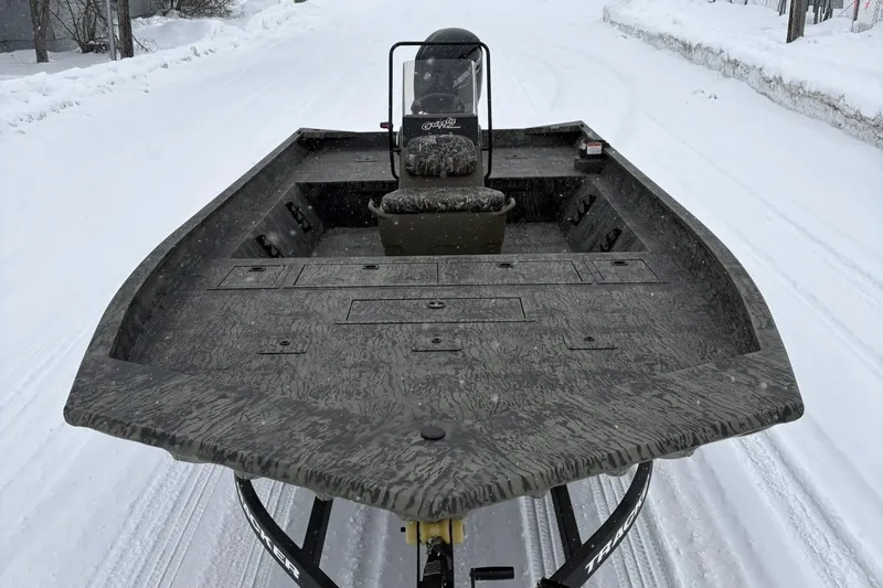 Slide: The Image of 2025 Tracker Grizzly 2072 CC boat on snowy road, showcasing spacious deck design. - 5