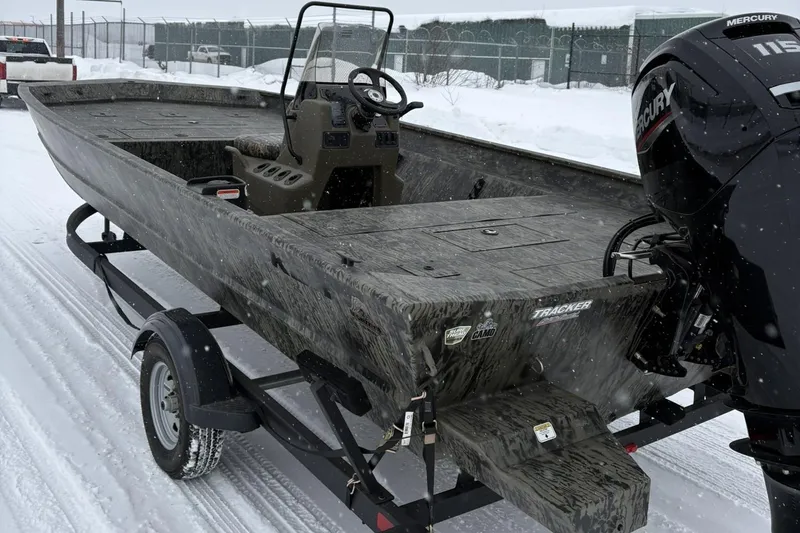 Slide: The Image of 2025 Tracker Grizzly 2072 CC boat on snowy trailer, featuring Mercury engine. - 7
