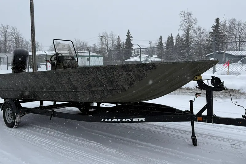 Slide: The Image of 2025 Tracker Grizzly 2072 CC boat on trailer in snowy setting. - 9