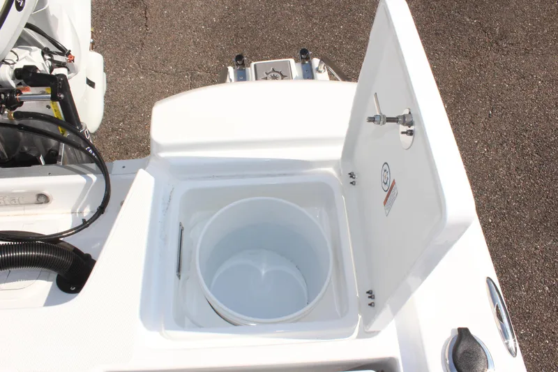 Slide: The Image of 2025 NauticStar 224 Bay boat livewell with open lid, showcasing interior design. - 10