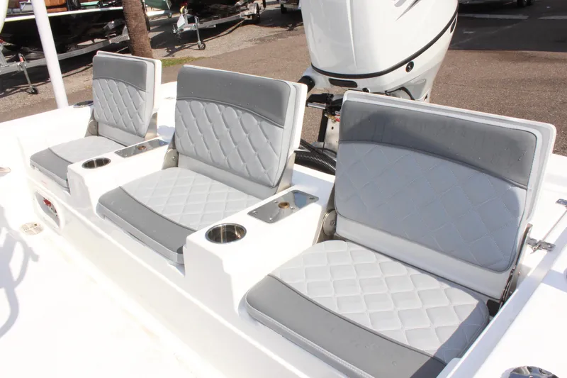 Slide: The Image of 2025 NauticStar 224 Bay boat seating with cup holders and modern design. - 12