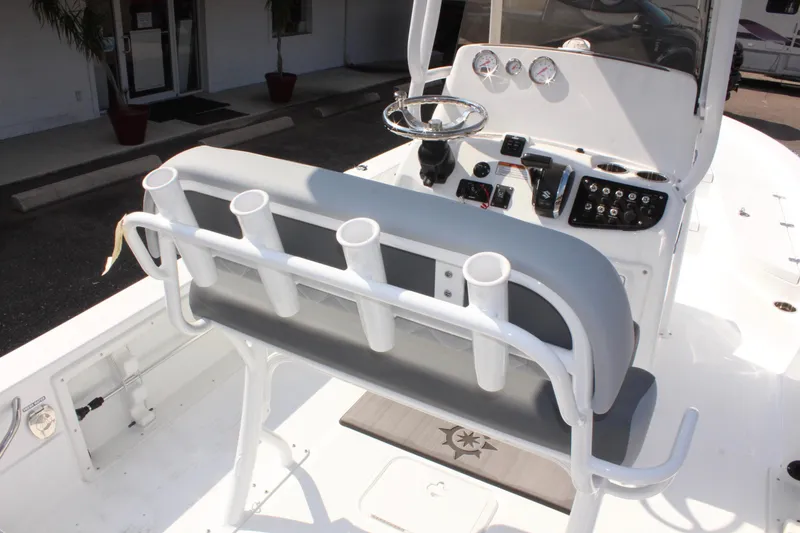 Slide: The Image of 2025 NauticStar 224 Bay boat interior with rod holders and control panel. - 14