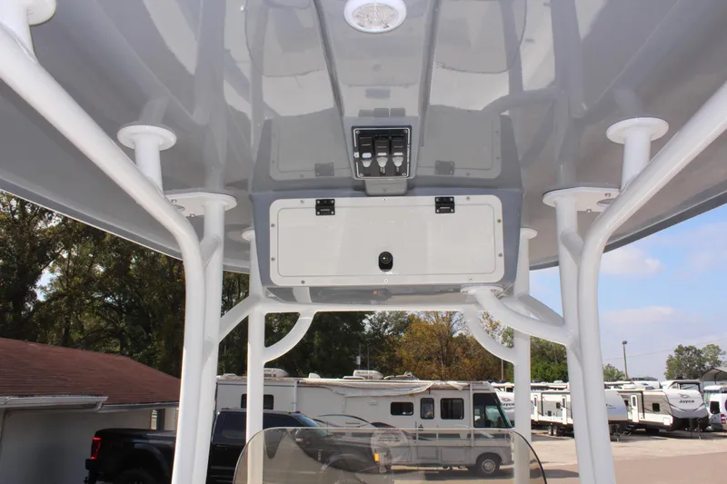 Slide: The Image of 2025 NauticStar 224 Bay boat console with overhead storage and controls. - 15