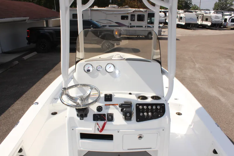 Slide: The Image of 2025 NauticStar 224 Bay boat console with steering wheel and controls. - 16
