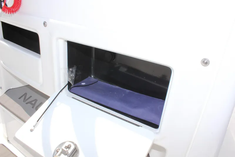 Slide: The Image of 2025 NauticStar 224 Bay boat storage compartment detail. - 19