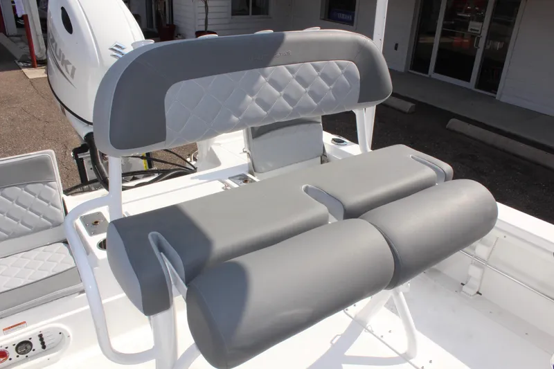 Slide: The Image of 2025 NauticStar 224 Bay boat with gray cushioned seating and diamond-patterned backrest. - 20