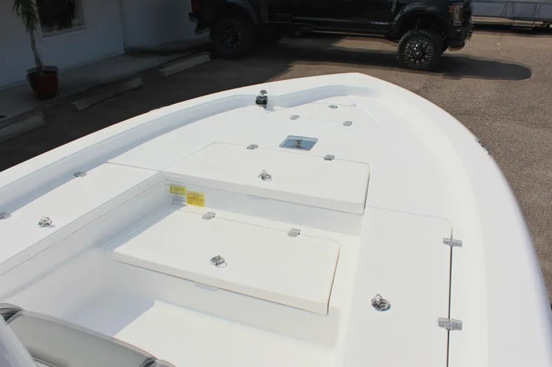 Slide: The Image of 2025 NauticStar 224 Bay boat deck with storage compartments. - 21