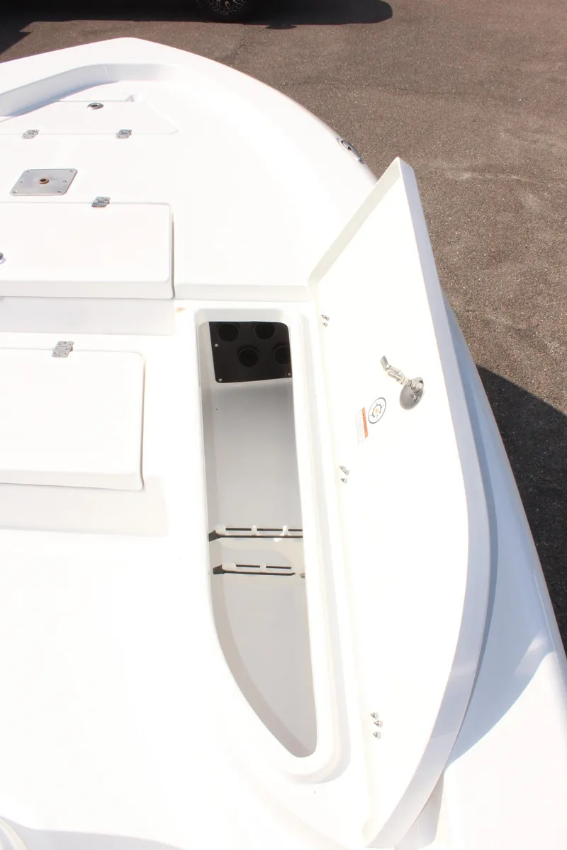 Slide: The Image of 2025 NauticStar 224 Bay boat deck with open storage compartment. - 24