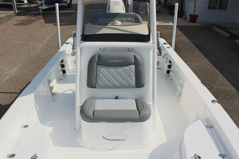 Slide: The Image of 2025 NauticStar 224 Bay boat interior with gray cushioned seating and console. - 28