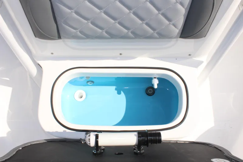 Slide: The Image of Livewell in 2025 NauticStar 224 Bay boat, featuring a sleek design and blue interior. - 31