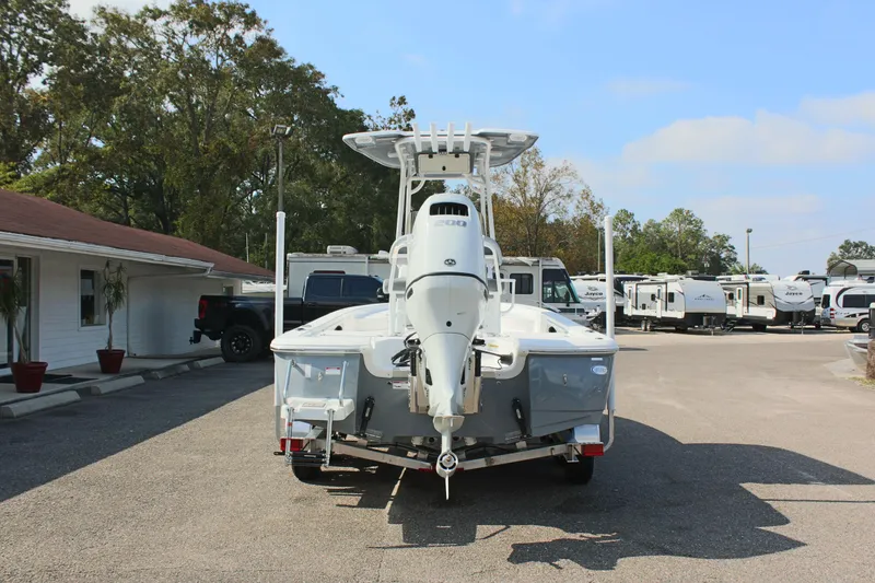 Slide: The Image of 2025 NauticStar 224 Bay boat on trailer in parking lot. - 6
