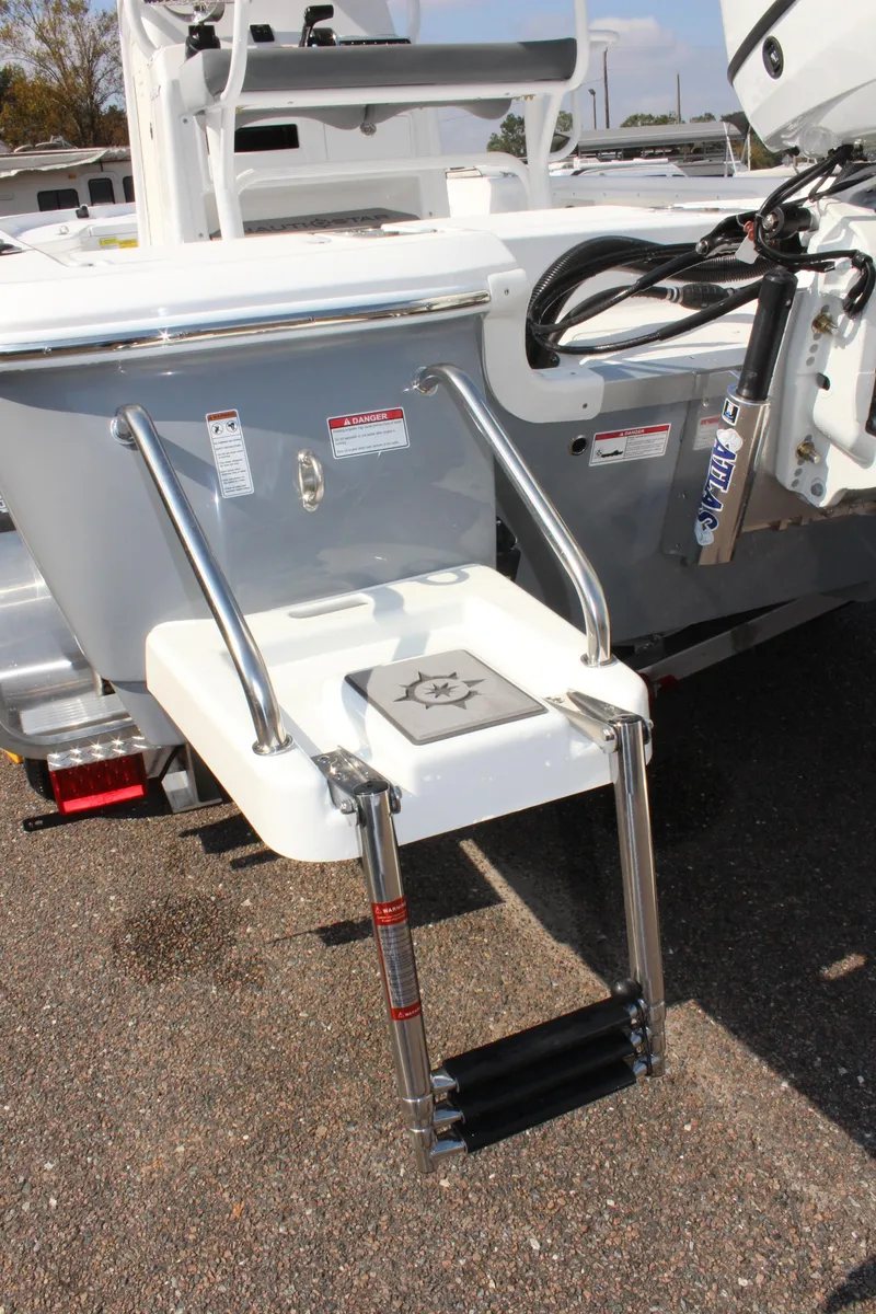 Slide: The Image of 2025 NauticStar 224 Bay boat with foldable swim ladder and motor mount. - 8