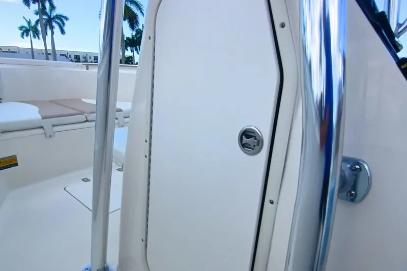 Slide: The Image of 2025 Bulls Bay 230 Center Console boat interior with seating and chrome details. - 27