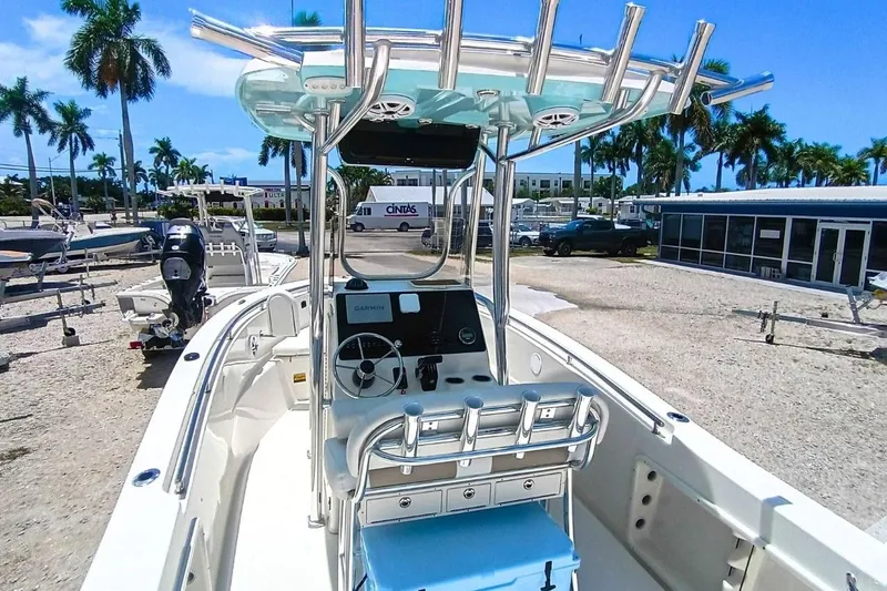 Slide: The Image of 2025 Bulls Bay 230 Center Console boat with modern helm, parked outdoors under clear skies. - 8