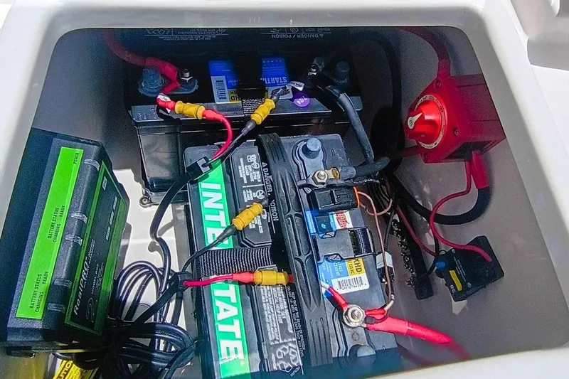 Slide: The Image of Battery compartment of 2025 Bulls Bay 230 Center Console boat with wiring and connections. - 51
