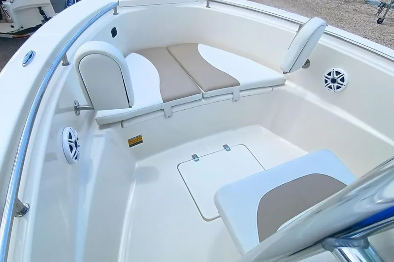 Slide: The Image of 2025 Bulls Bay 230 Center Console boat interior with cushioned seating and speakers. - 31