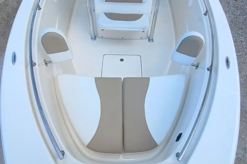 Slide: The Image of 2025 Bulls Bay 230 Center Console boat interior with cushioned seating and stainless steel rails. - 35