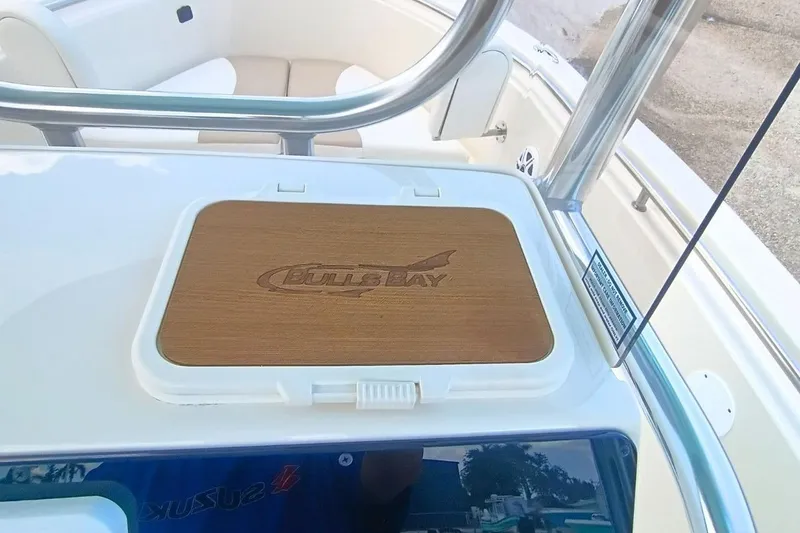Slide: The Image of 2025 Bulls Bay 230 Center Console boat interior with branded wooden panel. - 22
