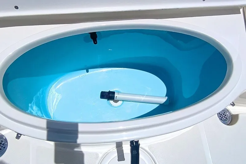 Slide: The Image of Livewell in 2025 Bulls Bay 230 Center Console boat, featuring a clean, blue interior. - 52