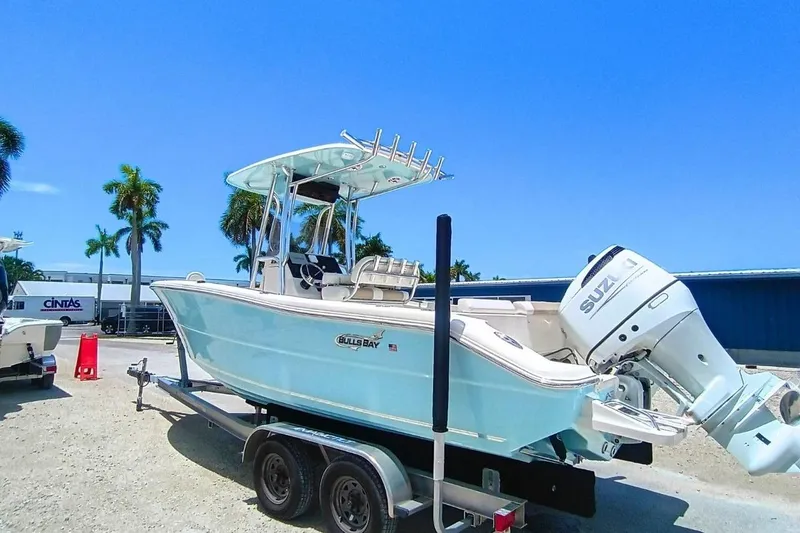 Slide: The Image of 2025 Bulls Bay 230 Center Console boat on trailer, featuring Suzuki outboard motor. - 6