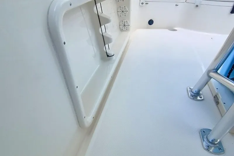 Slide: The Image of 2025 Bulls Bay 230 Center Console boat interior, featuring sleek white deck and sturdy metal fixtures. - 45