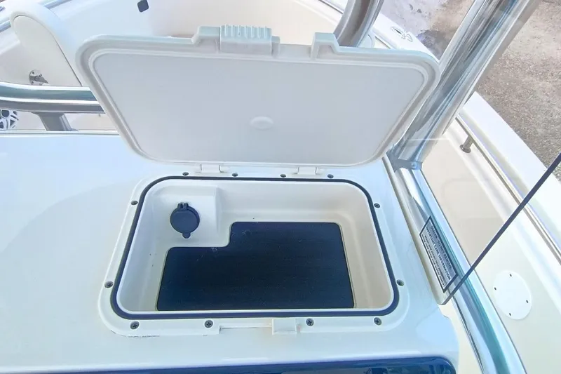 Slide: The Image of Open storage compartment on 2025 Bulls Bay 230 Center Console boat. - 23