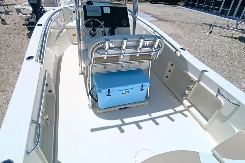 Slide: The Image of 2025 Bulls Bay 230 Center Console boat interior with steering console and blue cooler. - 7