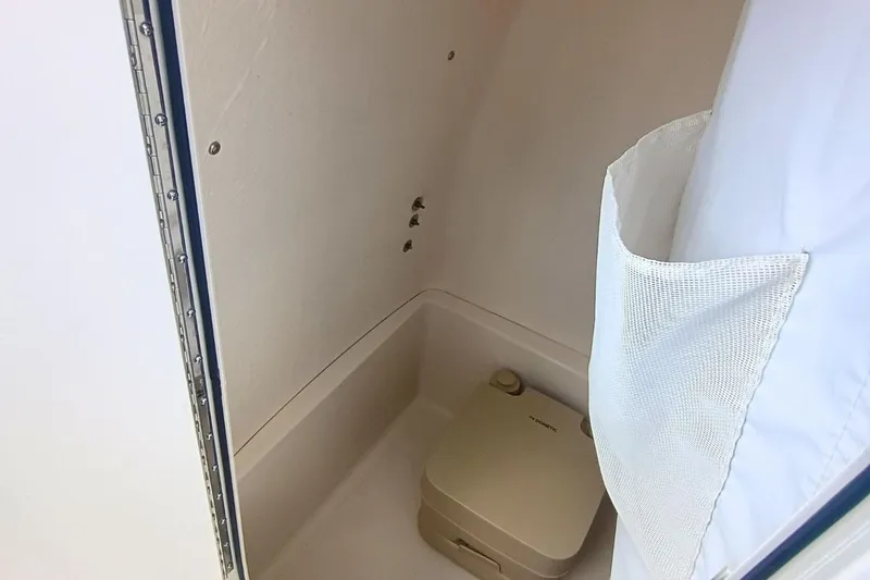 Slide: The Image of Interior of 2025 Bulls Bay 230 Center Console boat with portable toilet. - 29