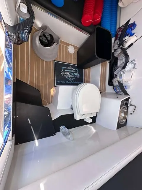 Slide: The Image of 2015 Nor-Tech 340 Sport Center Console interior with toilet and storage compartments. - 27