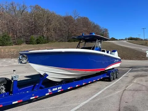 Slide: The Image of 2015 Nor-Tech 340 Sport Center Console boat on trailer in parking lot. - 3
