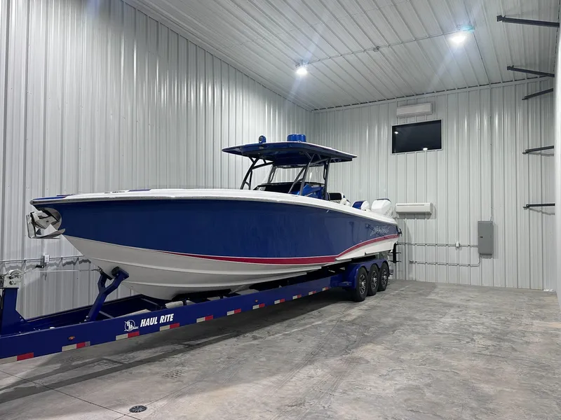 Slide: The Image of 2015 Nor-Tech 340 Sport Center Console boat in storage on trailer. - 8