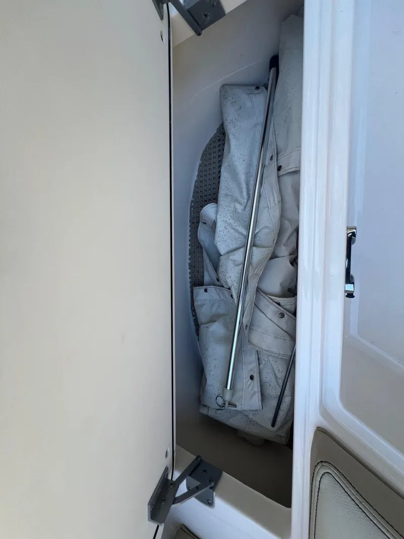 Slide: The Image of Storage compartment in 2017 Pursuit DC 295 Dual Console boat. - 27