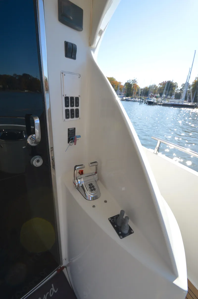 Slide: The Image of 2007 Marquis 59 yacht control panel by the water. - 11