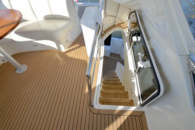 Slide: The Image of Luxurious 2007 Marquis 59 yacht interior with elegant wooden flooring and staircase. - 12