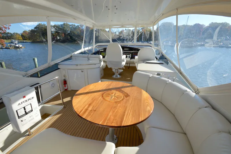 Slide: The Image of Luxurious 2007 Marquis 59 yacht interior with elegant seating and scenic water views. - 13