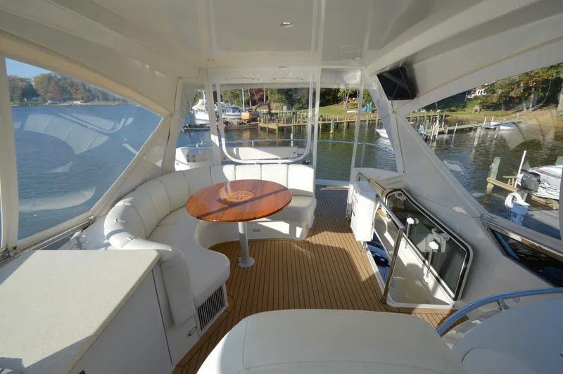 Slide: The Image of Luxurious 2007 Marquis 59 yacht interior with elegant seating and wooden table. - 15