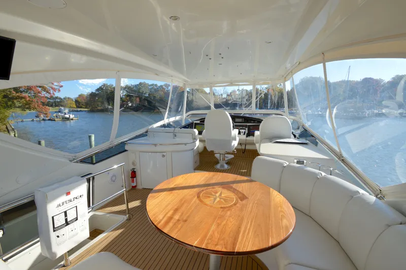 Slide: The Image of Luxurious 2007 Marquis 59 yacht interior with elegant seating and scenic water views. - 17