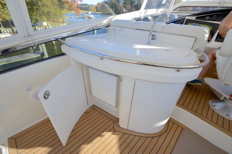 Slide: The Image of Luxury yacht interior with open cabinet, Marquis 59, 2007 model, featuring sleek design and wood flooring. - 18