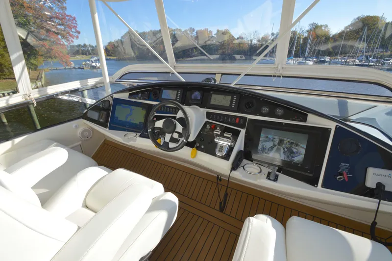 Slide: The Image of Luxurious 2007 Marquis 59 yacht helm with advanced navigation systems and plush seating. - 21
